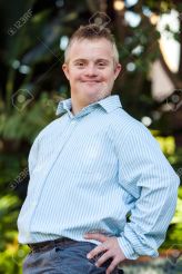 29870179-portrait-of-cute-boy-with-down-syndrome-posing-at-camera-outdoors-